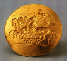 Gold ring with Nike driving a four-horse chariot, about 400-350 BC. London, British Museum GB 1842.7-28.134; from the Thomas Burgon collection.